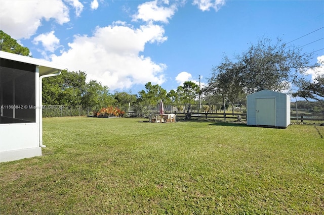 view of yard with a storage unit and a sunroom