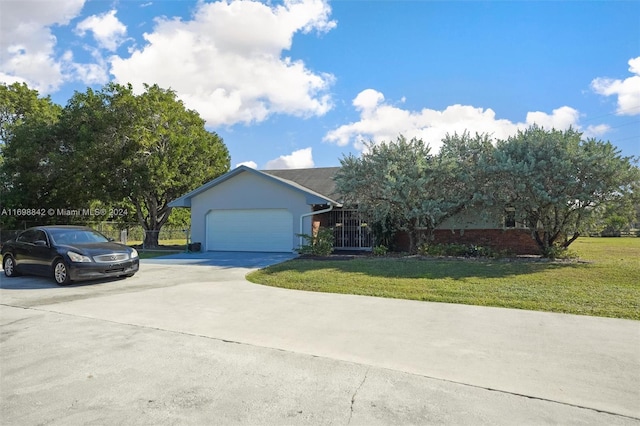 view of front of property with a garage and a front lawn