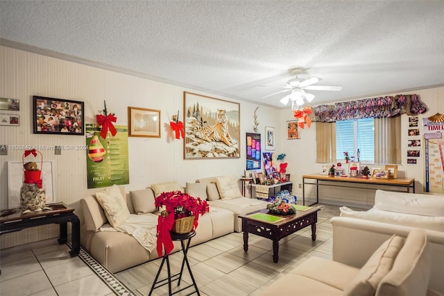 living room with ceiling fan, light tile patterned flooring, and a textured ceiling