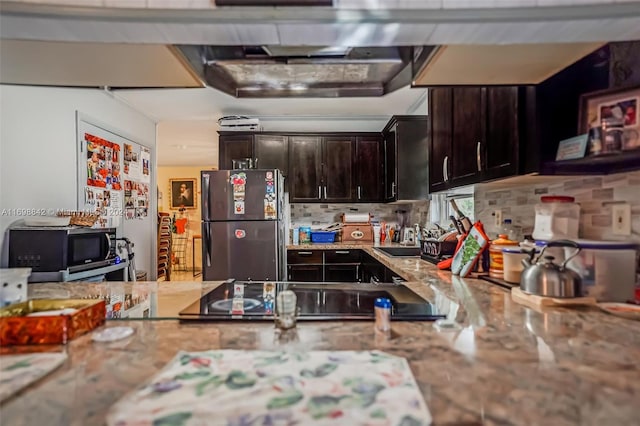 kitchen featuring dark brown cabinets, sink, appliances with stainless steel finishes, and tasteful backsplash