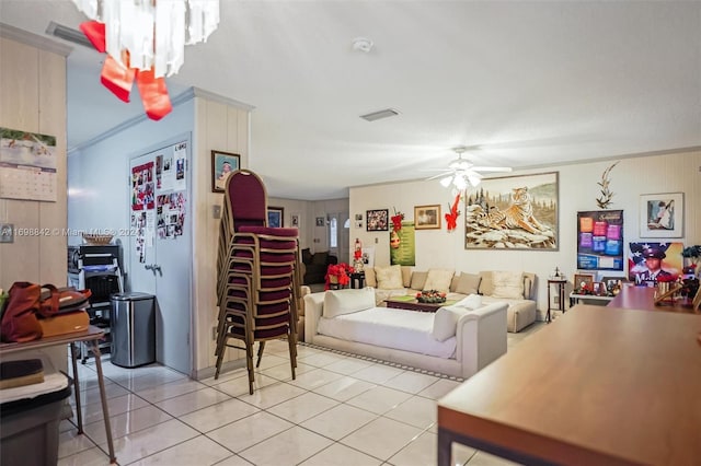 living room with ceiling fan, light tile patterned floors, and crown molding