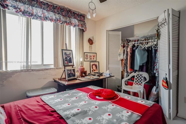 bedroom with a closet and a textured ceiling