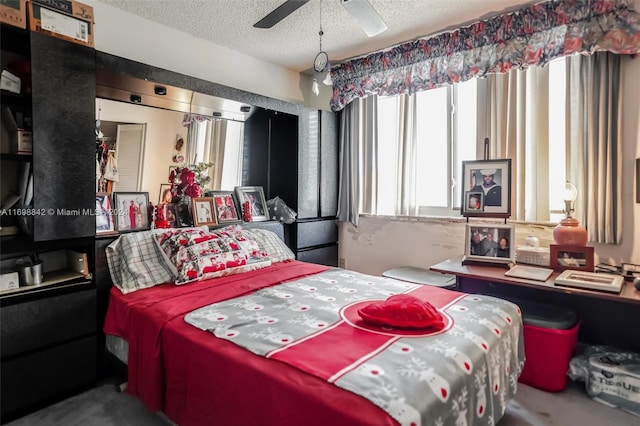 bedroom with a textured ceiling and ceiling fan