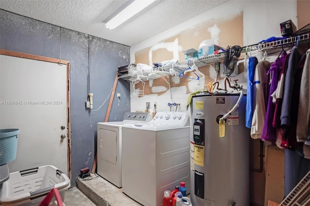 clothes washing area with washer and clothes dryer and water heater