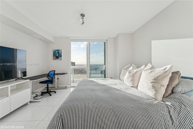 bedroom with floor to ceiling windows and light tile patterned floors