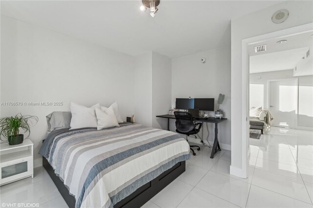 tiled bedroom featuring floor to ceiling windows and access to outside