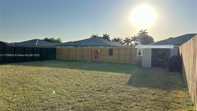 view of yard featuring an outbuilding and a fenced backyard