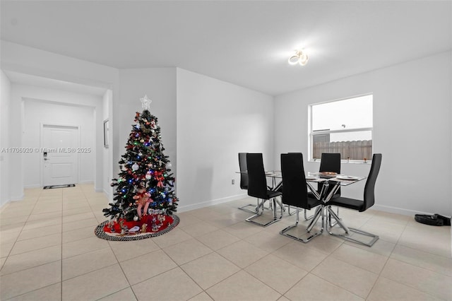 dining room with light tile patterned floors and baseboards