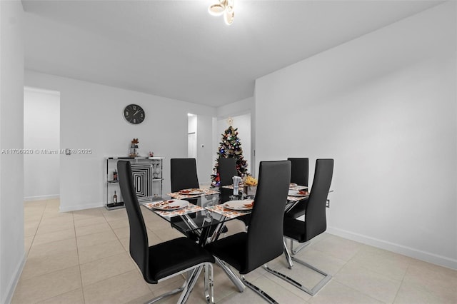 dining area featuring light tile patterned floors and baseboards