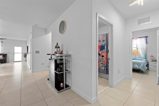 kitchen featuring white cabinets, appliances with stainless steel finishes, and light tile patterned floors