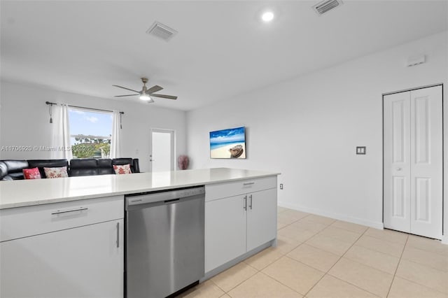 kitchen with stainless steel dishwasher, light countertops, visible vents, and white cabinetry