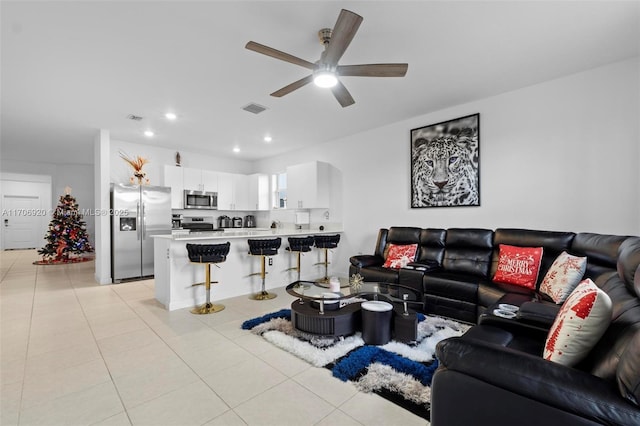 living room with light tile patterned floors, visible vents, ceiling fan, and recessed lighting