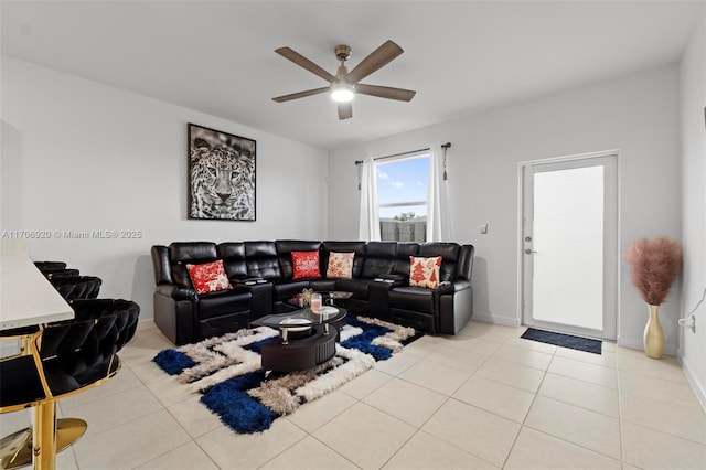 living area featuring light tile patterned floors, baseboards, and ceiling fan