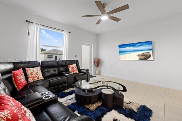 tiled bedroom featuring a tray ceiling and ceiling fan