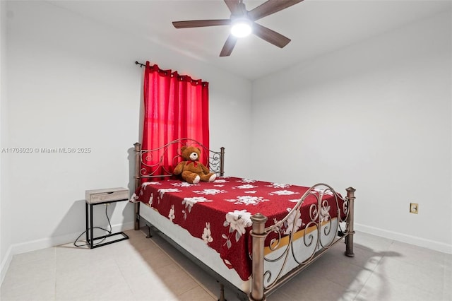 tiled bedroom featuring ceiling fan and baseboards