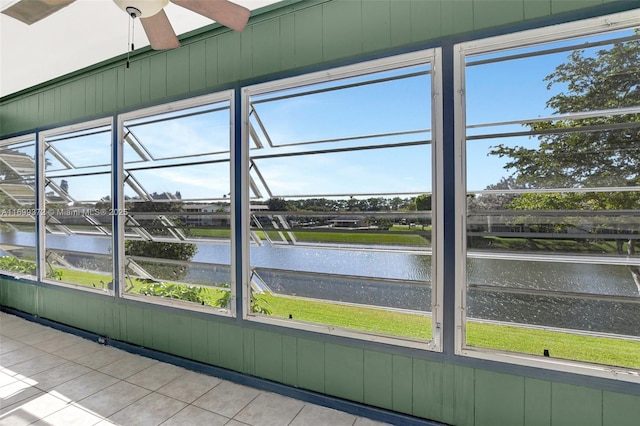 unfurnished sunroom featuring a water view and a wealth of natural light