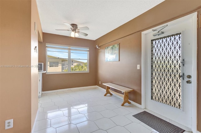 foyer entrance featuring a textured ceiling and ceiling fan