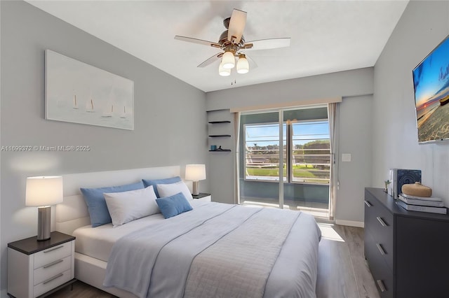 bedroom with ceiling fan, dark wood-type flooring, and access to outside