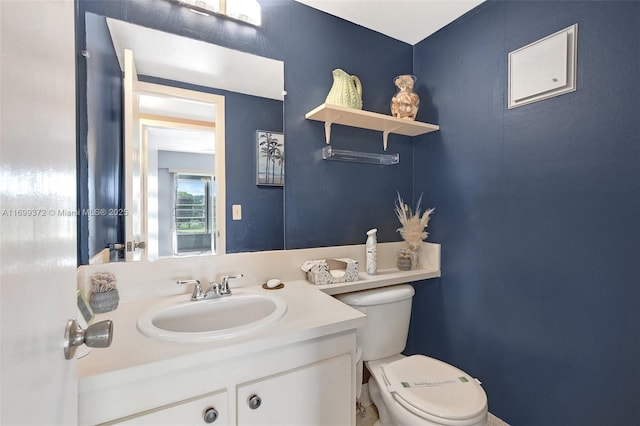 bathroom featuring toilet and vanity