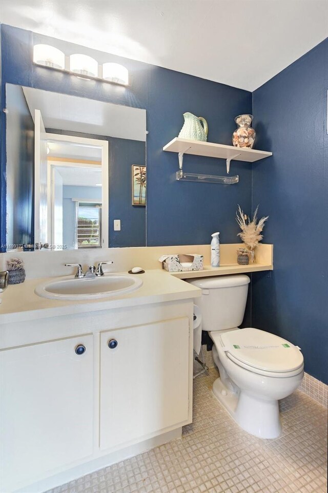 bathroom featuring vanity, toilet, and tile patterned floors