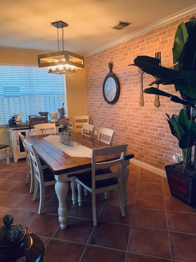 tiled dining space featuring brick wall and ornamental molding