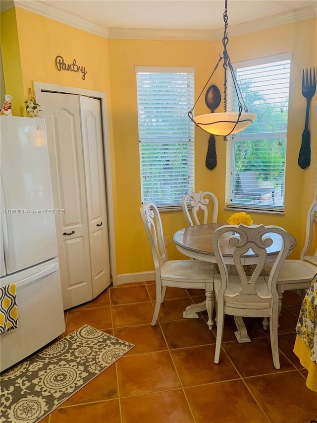 tiled dining room with crown molding