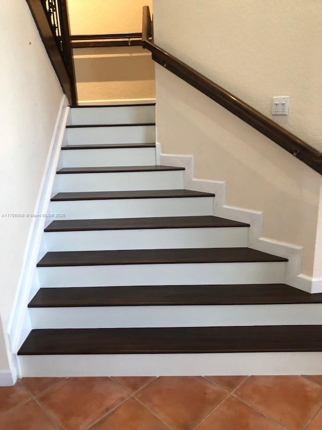 stairs featuring tile patterned floors