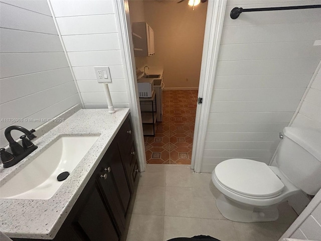 bathroom featuring toilet, vanity, and tile patterned floors