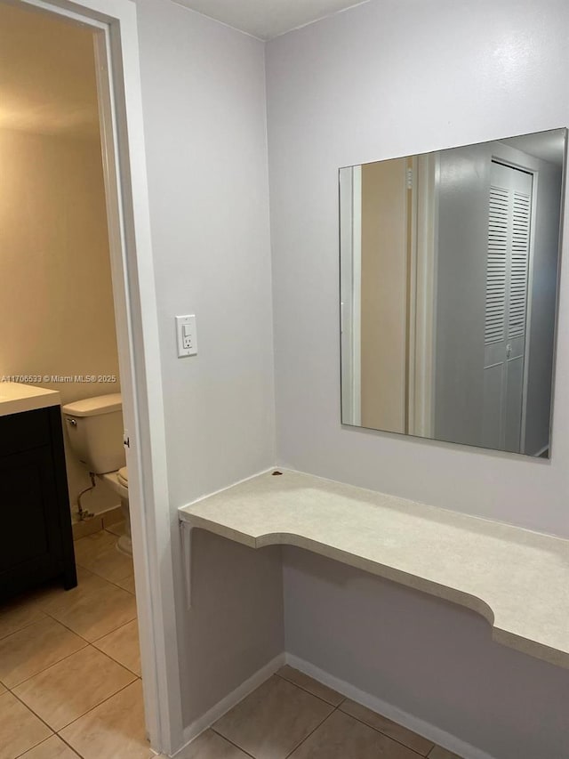 bathroom with tile patterned floors, vanity, and toilet