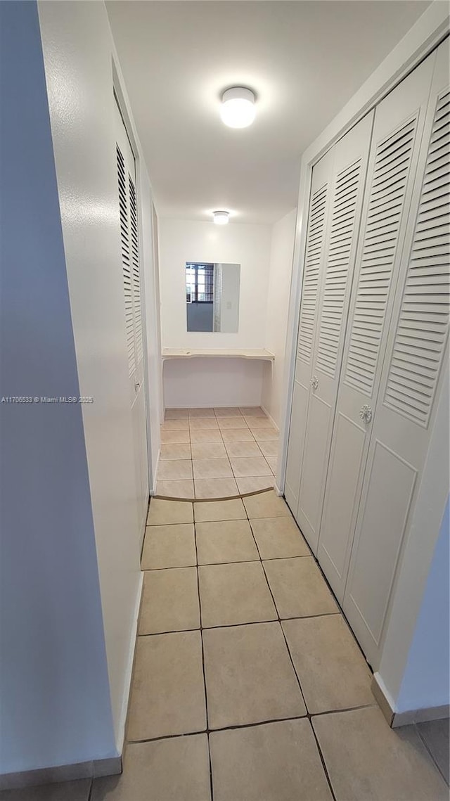 corridor featuring light tile patterned flooring