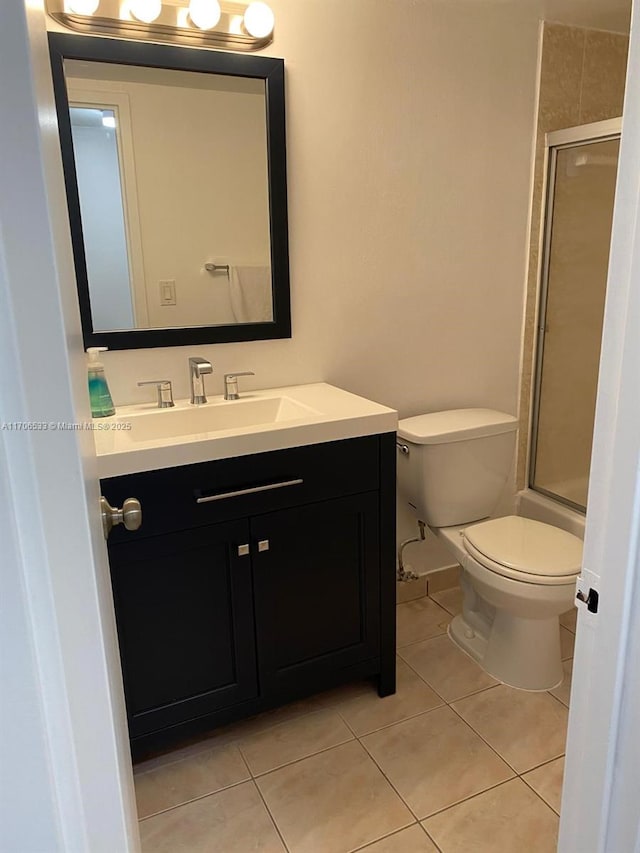 full bathroom featuring toilet, tile patterned floors, vanity, and enclosed tub / shower combo