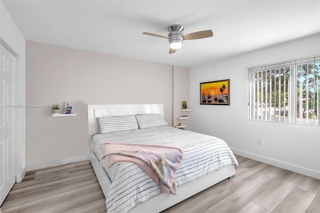 bedroom with ceiling fan and light hardwood / wood-style flooring