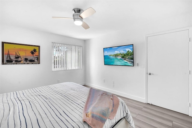 bedroom with ceiling fan and light hardwood / wood-style flooring