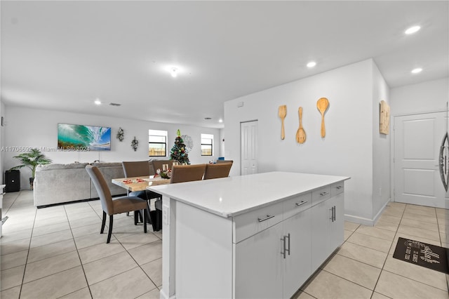 kitchen featuring a center island, white cabinets, and light tile patterned floors