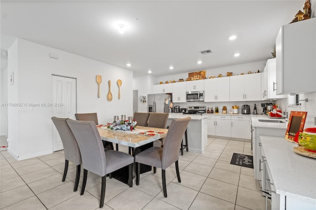 tiled dining area featuring sink