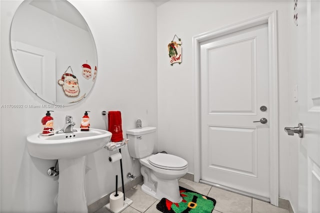 bathroom with tile patterned flooring, toilet, and sink