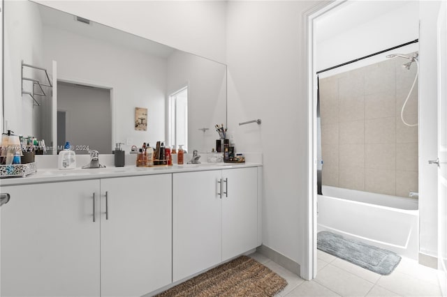 bathroom with tile patterned flooring, vanity, and tiled shower / bath combo