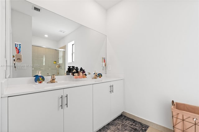 bathroom with vanity, tile patterned floors, and a shower with door