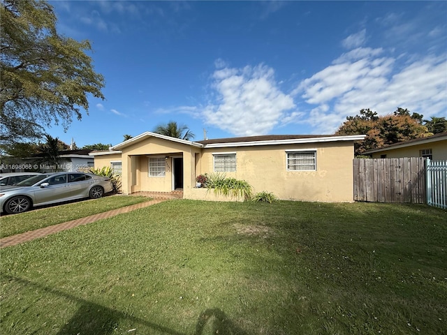 ranch-style home with a front lawn