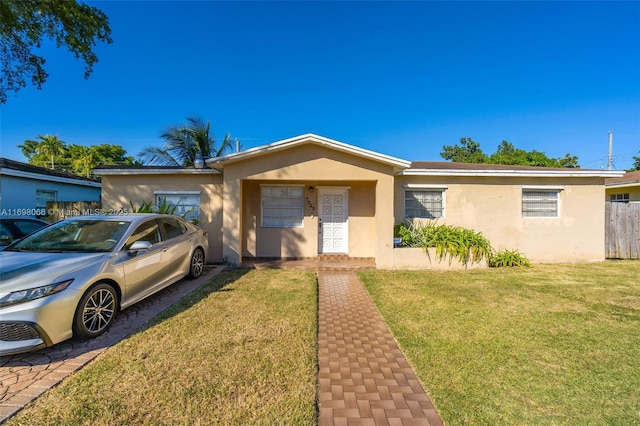 ranch-style home with a front yard