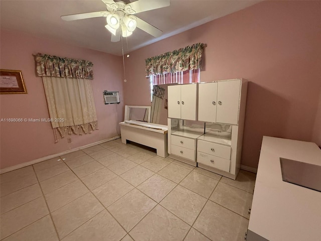 tiled bedroom featuring ceiling fan and a wall unit AC