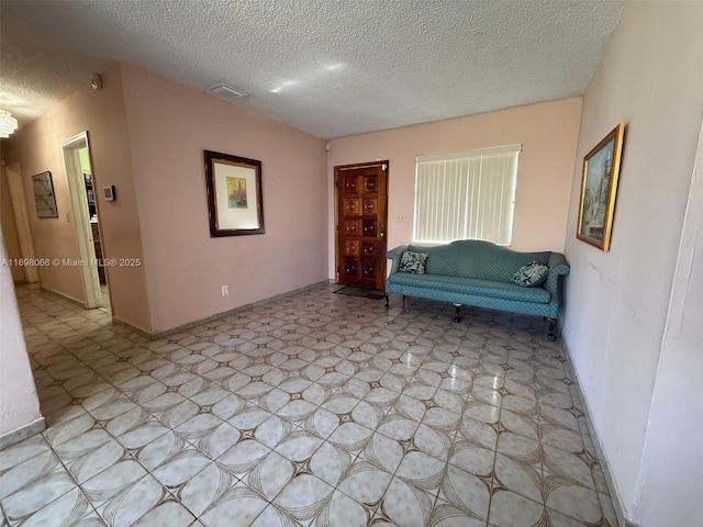 unfurnished room featuring a textured ceiling