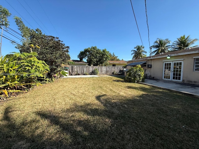 view of yard featuring french doors and a patio area