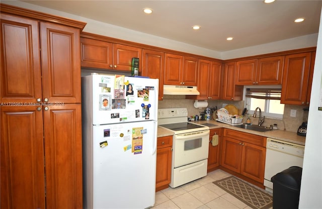 kitchen featuring decorative backsplash, light tile patterned flooring, white appliances, and sink