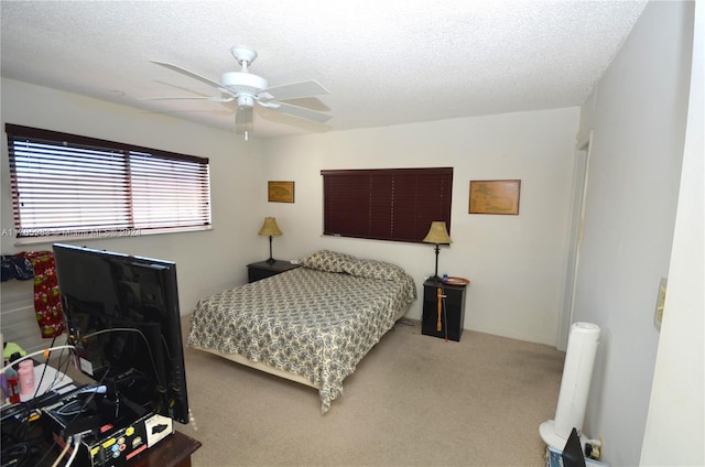 bedroom with carpet flooring, ceiling fan, and a textured ceiling