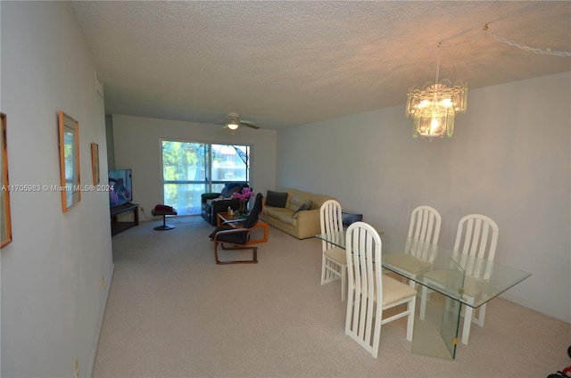 interior space featuring a textured ceiling, carpet floors, and ceiling fan with notable chandelier