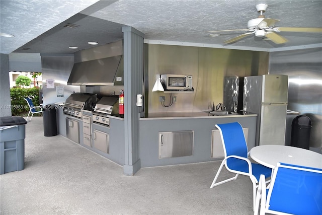 kitchen featuring refrigerator, light colored carpet, and range hood