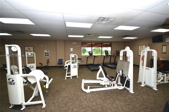 workout area featuring a drop ceiling and dark carpet