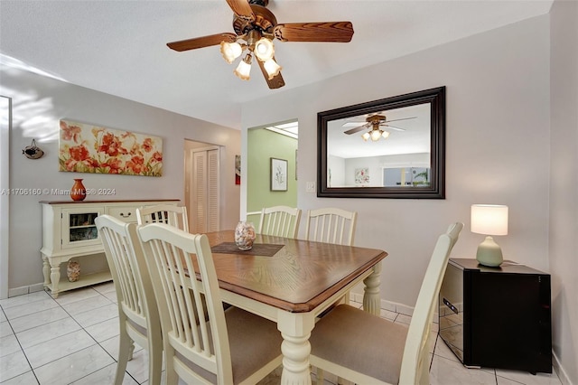 tiled dining area featuring ceiling fan