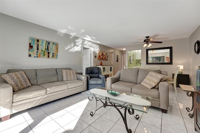 tiled living room featuring ceiling fan